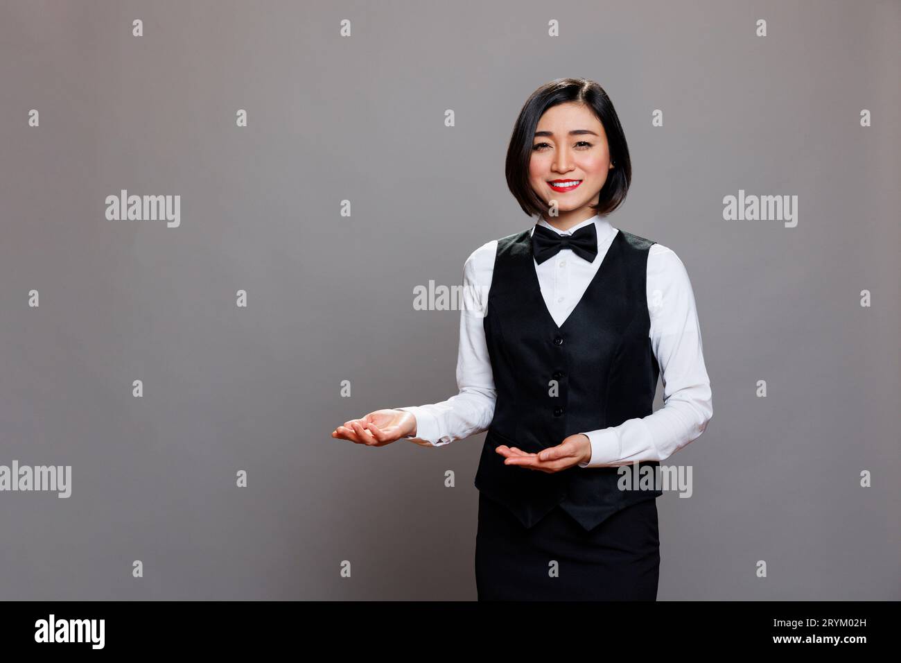 Cheerful woman welcoming guests hi-res stock photography and images - Alamy
