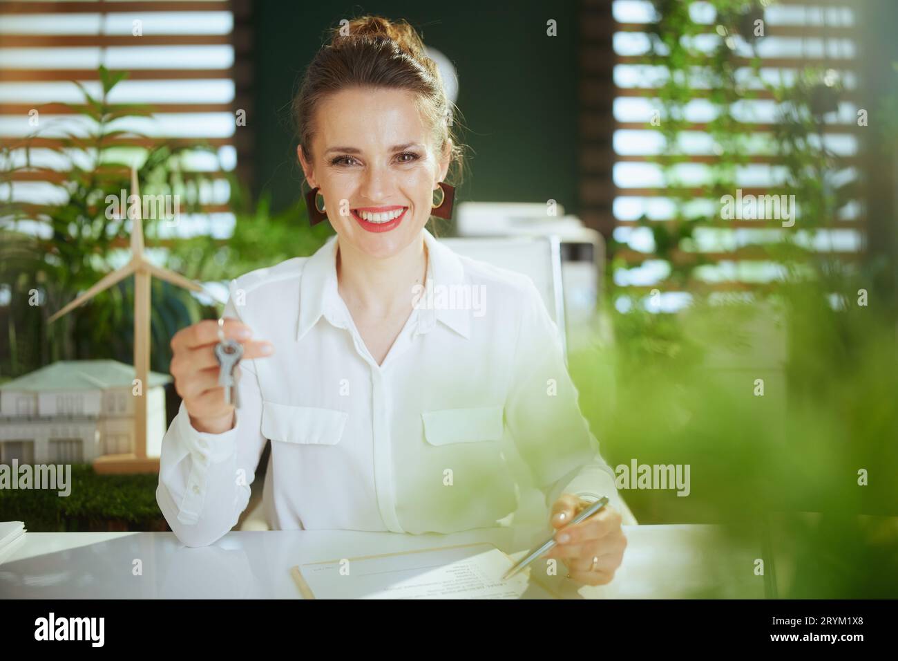 Eco real estate business. happy stylish business woman in modern green