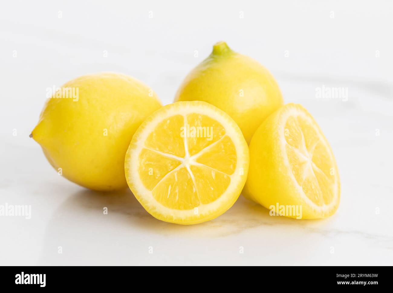 Dwarf lemons isolated on white marble background Stock Photo