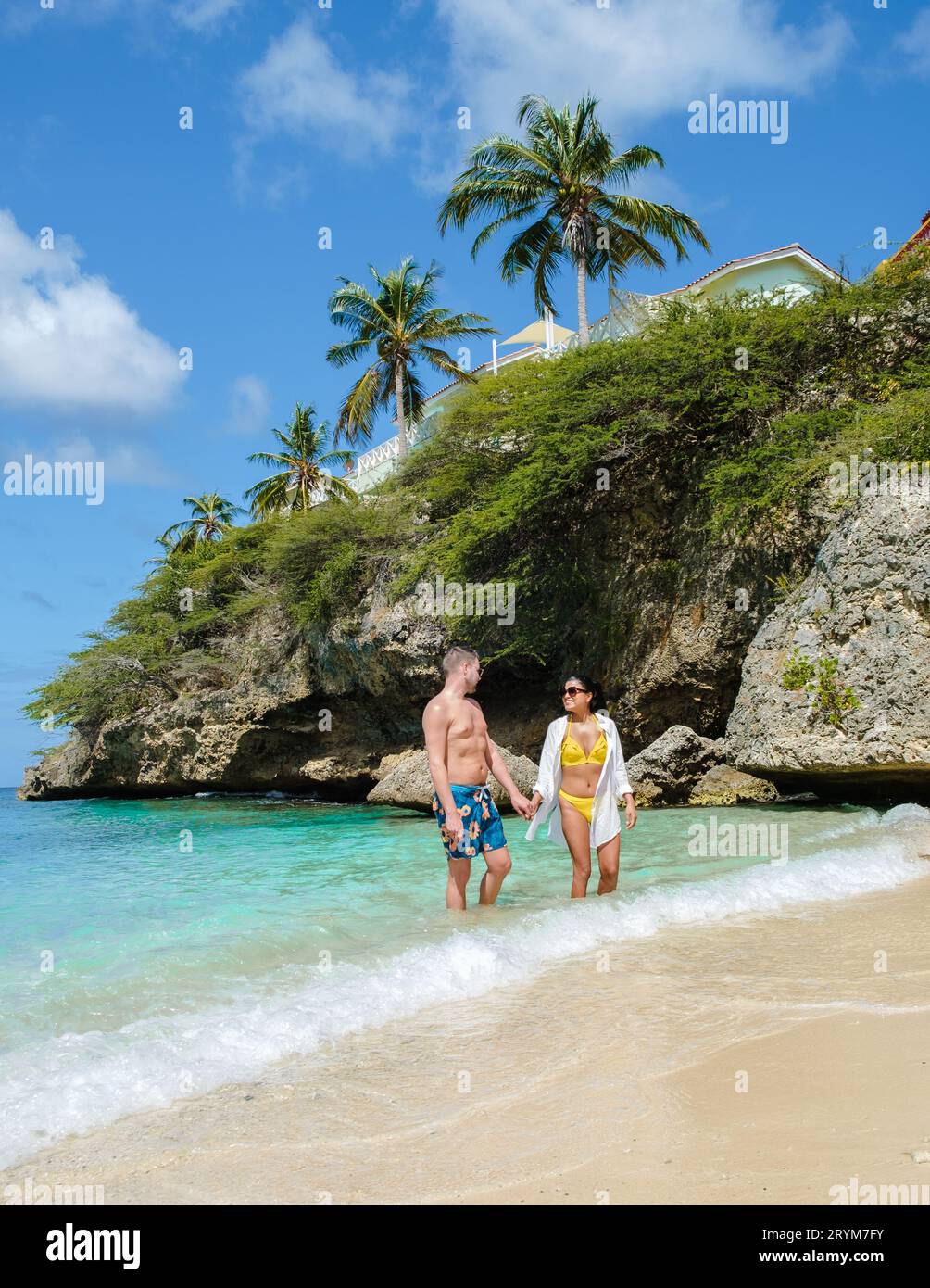 A couple of men and woman in swimshort and bikini at Playa Lagun Beach