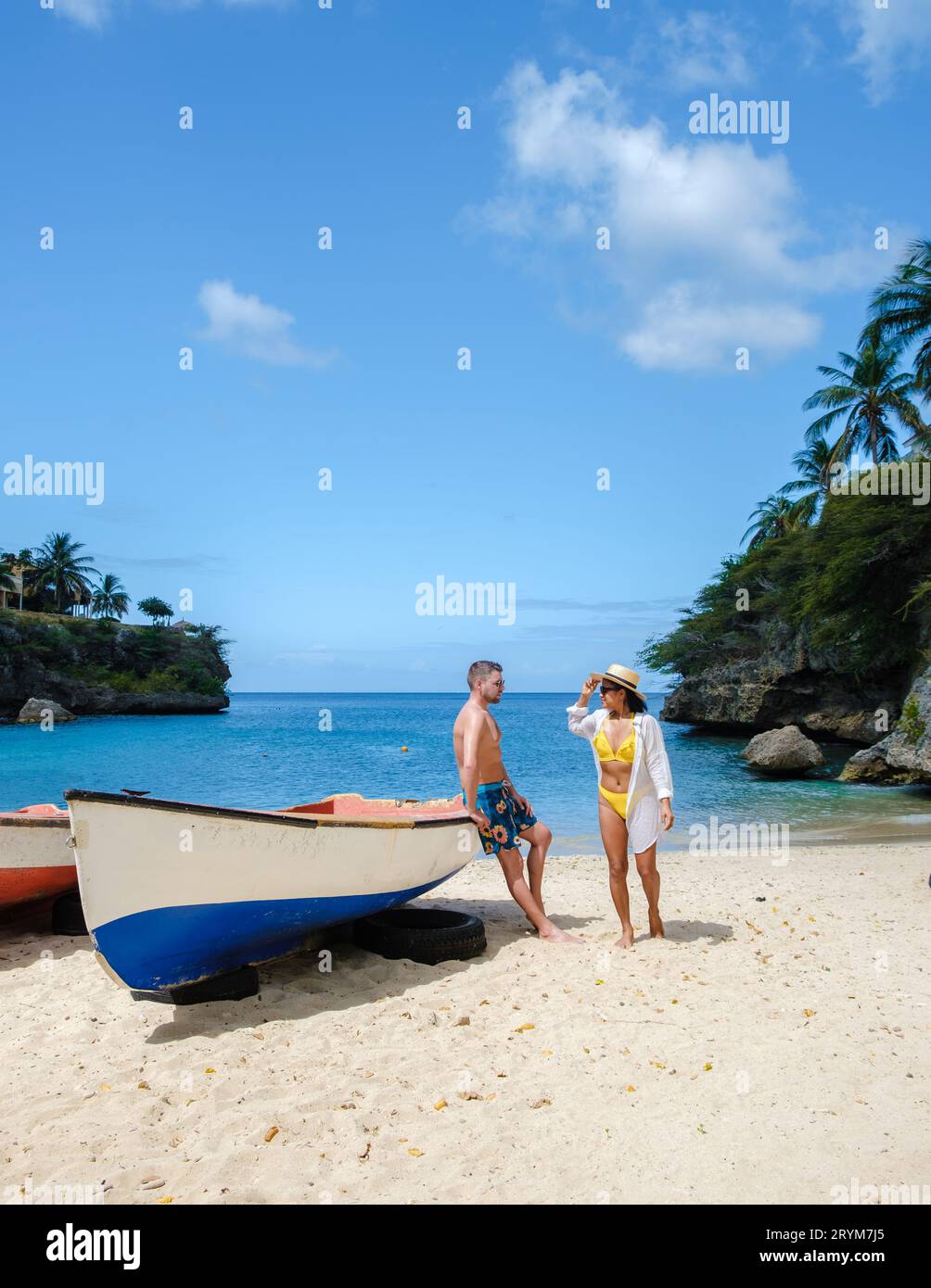 A couple of men and woman in swimshort and bikini at Playa Lagun Beach