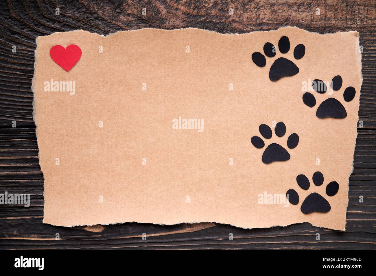 Postcard with paw foot trail icon and red heart, paper art style. Animal love concept, greeting card, invitation mockup Stock Photo