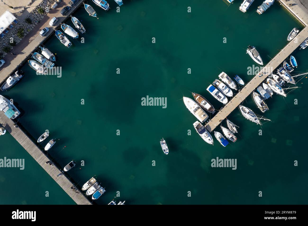 Drone aerial scenery of a fishing port. Fishing boats and yachts moored ...