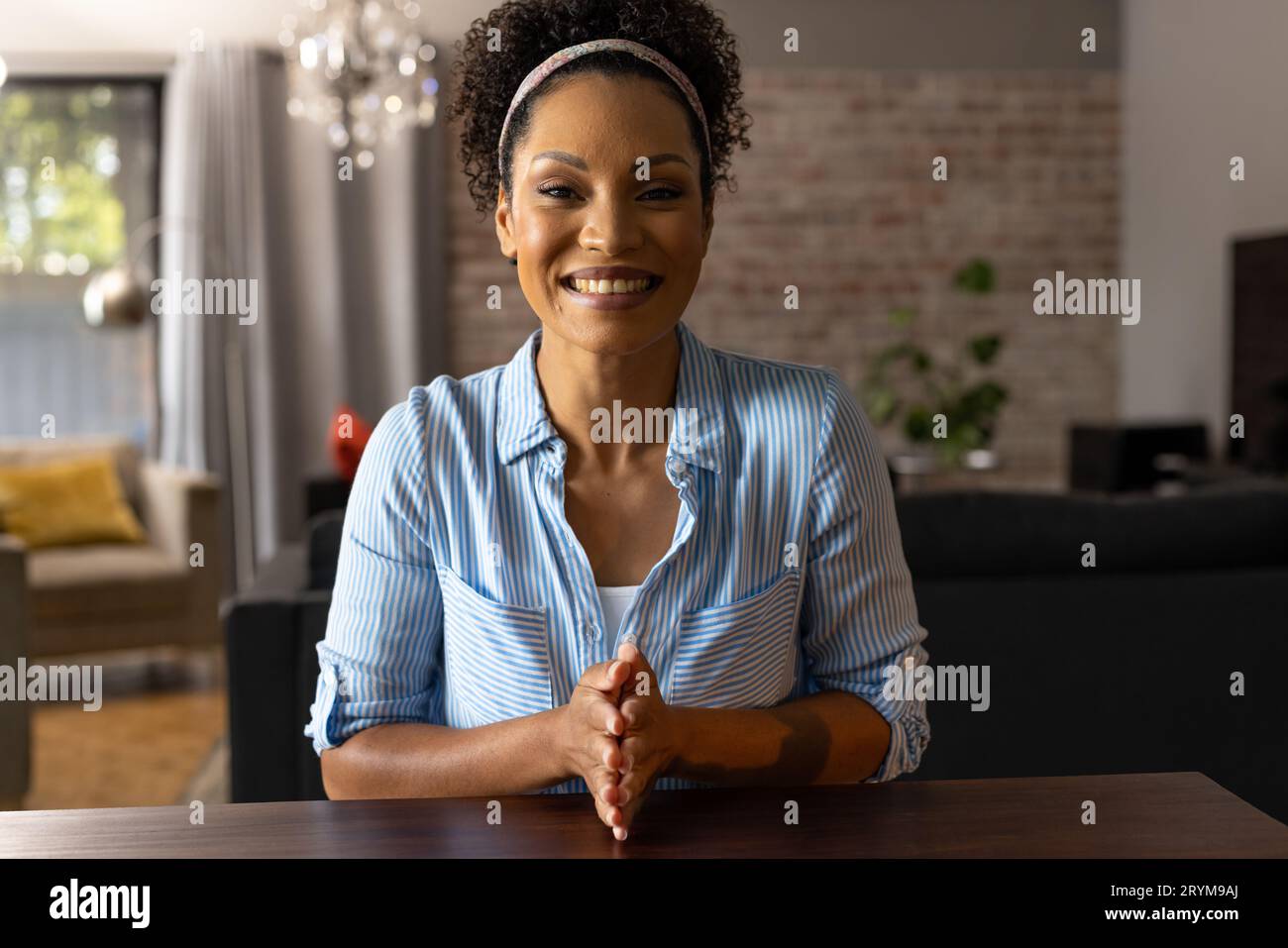Happy african american woman making video call at home, smiling and ...