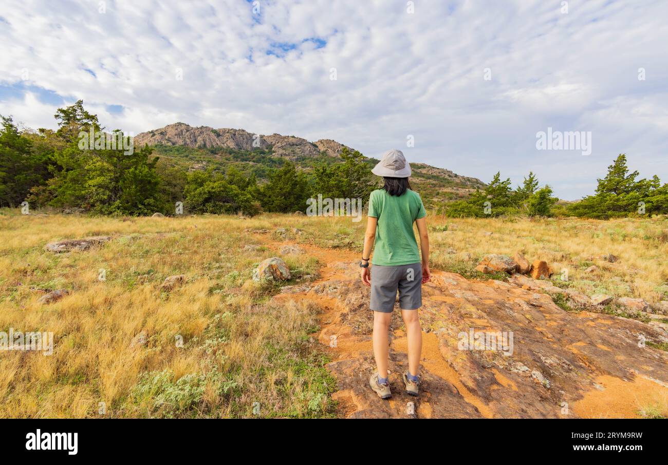 Woman hiking in the Elk Mountain Trail of the Wichita Mountains National Wildlife Refuge at Oklahoma Stock Photo