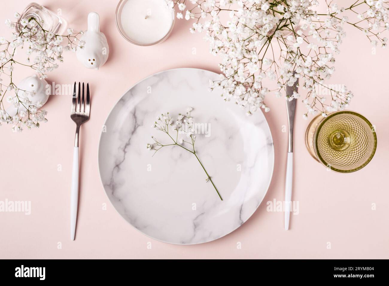 Romantic table setting in pink colors. White flowers decor Stock Photo