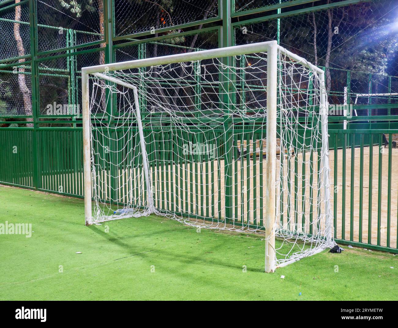 football field in the evening. Artificial lawn. Available infrastructure. Empty sports ground. Football game concept. Sports mesh. Entertainment in th Stock Photo