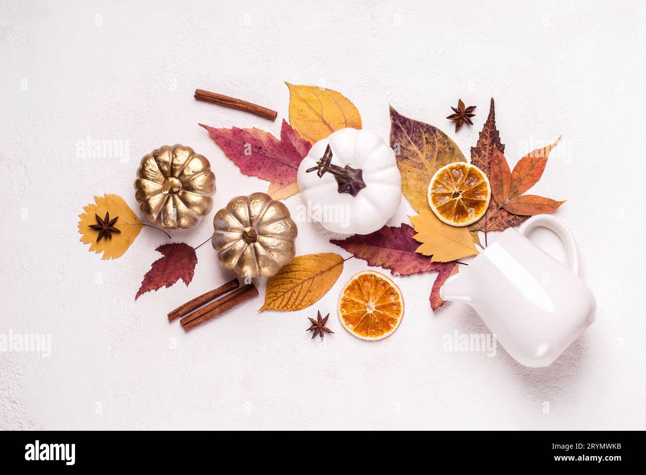 Creative layout made of golden pumpkins and leaves. Autumn floral composition Stock Photo