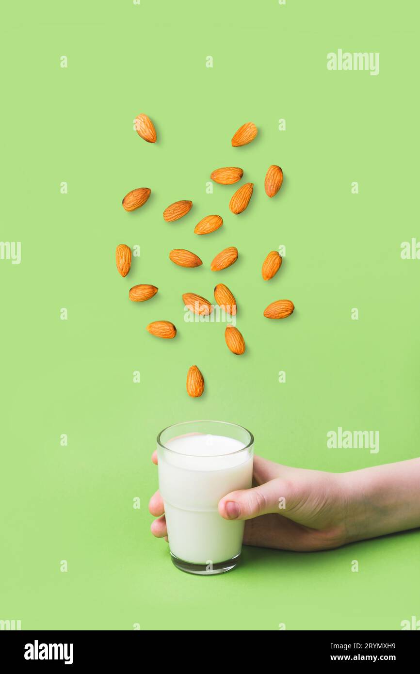 Children's hand holds glass of non diary milk. Health care, diet and nutrition concept Stock Photo