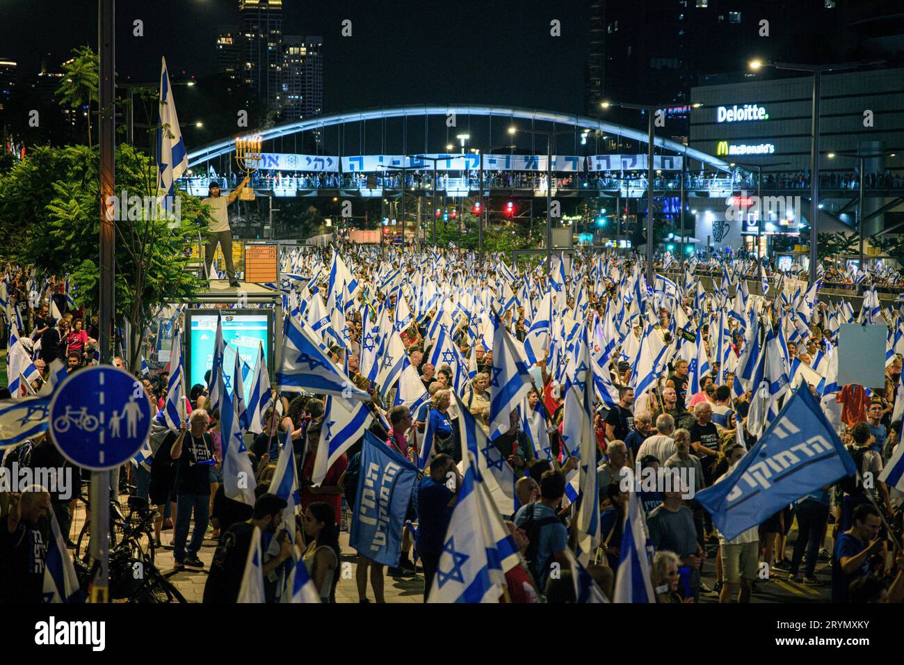 Tel Aviv, Israel. 30th Sep, 2023. A protestor holds a burning Menorah