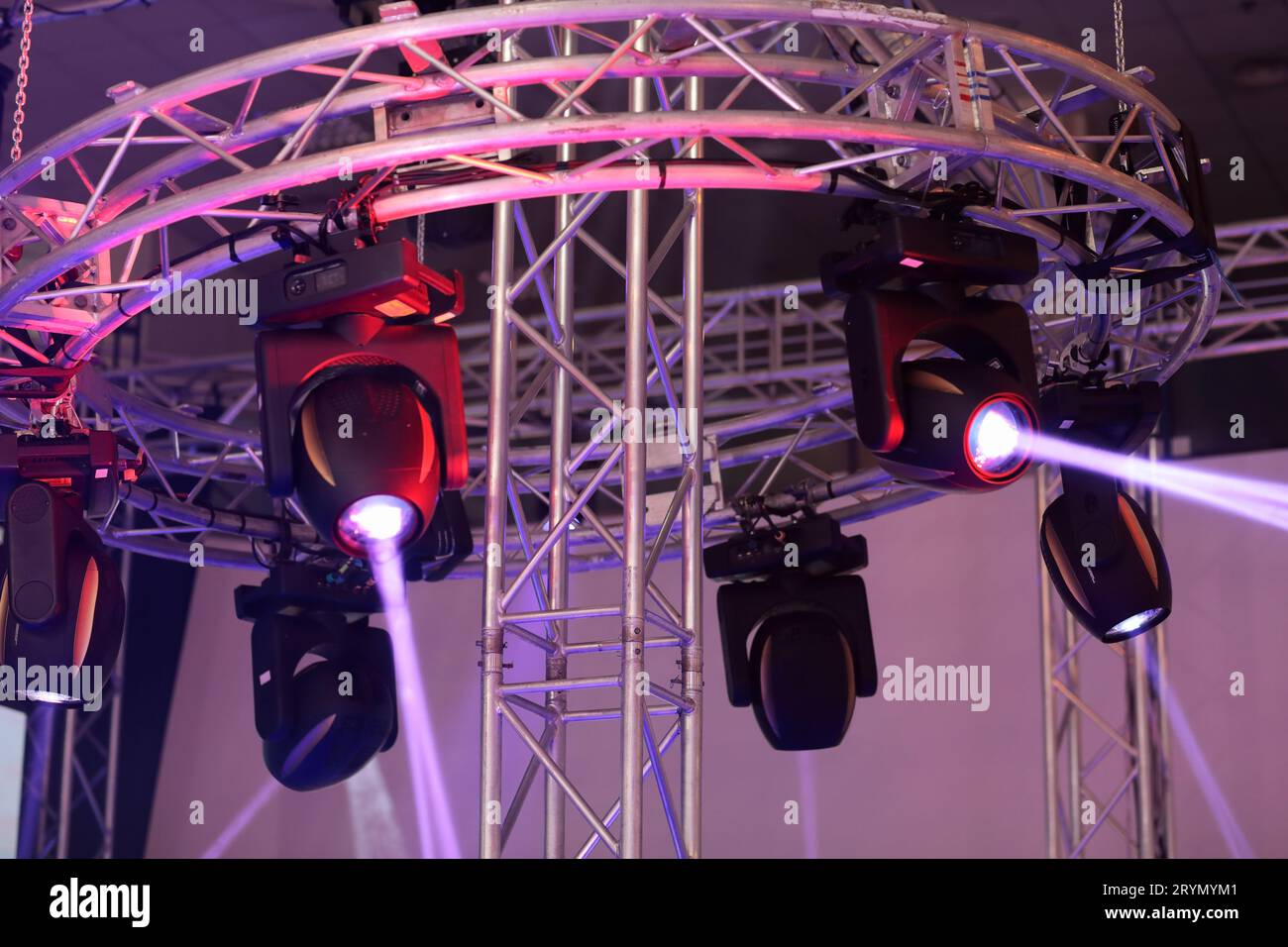 LED stage lighting. Moving heads hanging on truss. Selective focus. Stock Photo