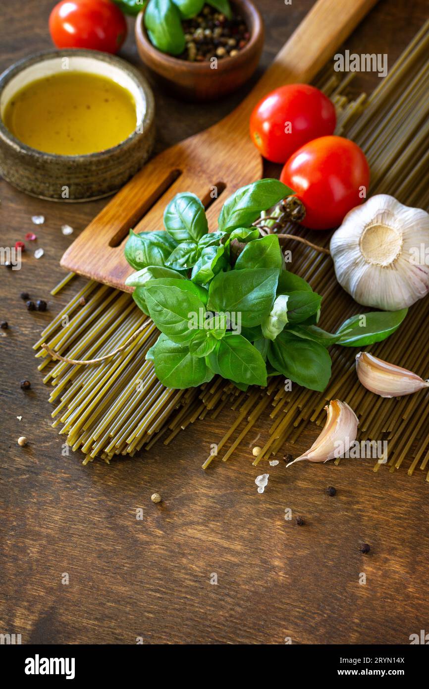 Ingredients for italy cuisine. Spinach spaghetti, herbs, spices, olive
