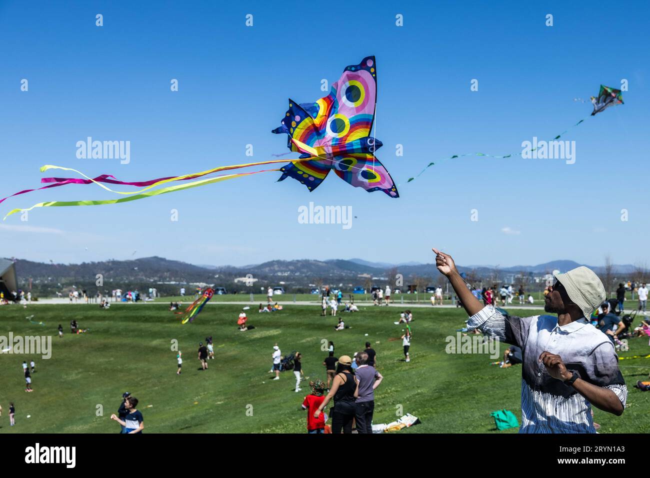 Canberra, Australia. 1st Oct, 2023. A man flies a kite during the Kite