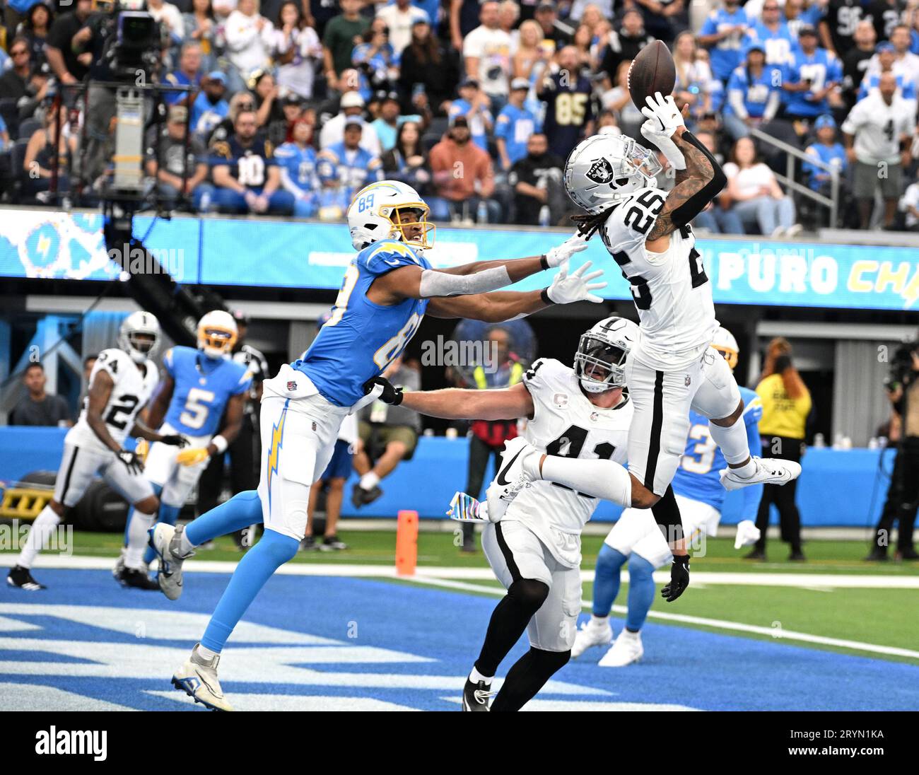 Raiders safety Trevon Moehrig (25) trips up Los Angeles Chargers