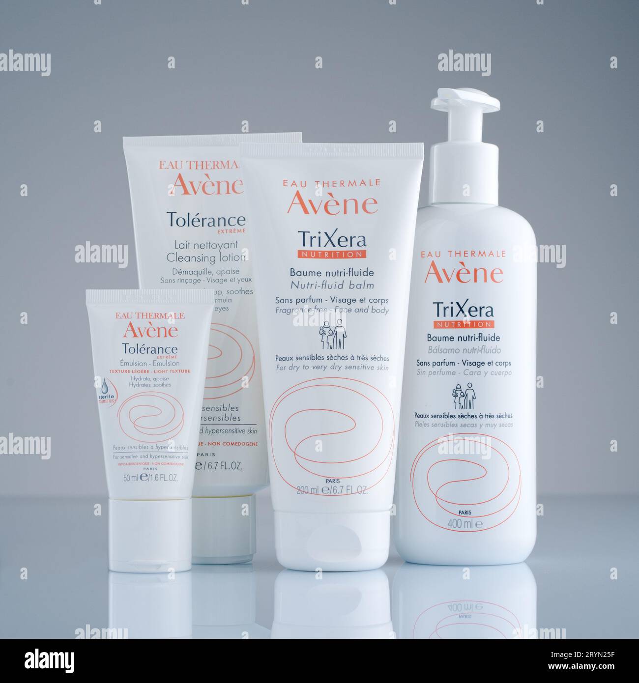 Cluster of four Avène products on a grey background Stock Photo Alamy