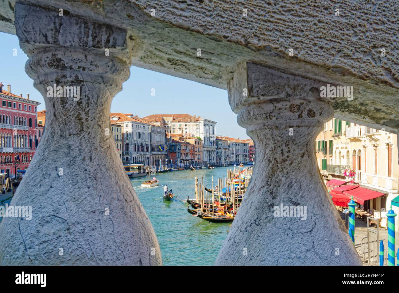 View through the stone railing of the Rialto Bridge onto the Grand Canal, Venice, Italy Stock Photo