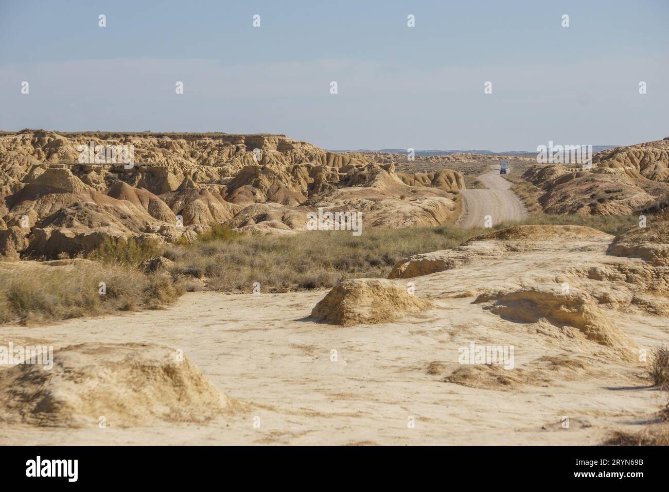 Gravel road through desert landscape of the arid plateau of the Bardenas Reales, Arguedas, Navarra, Spain Stock Photo