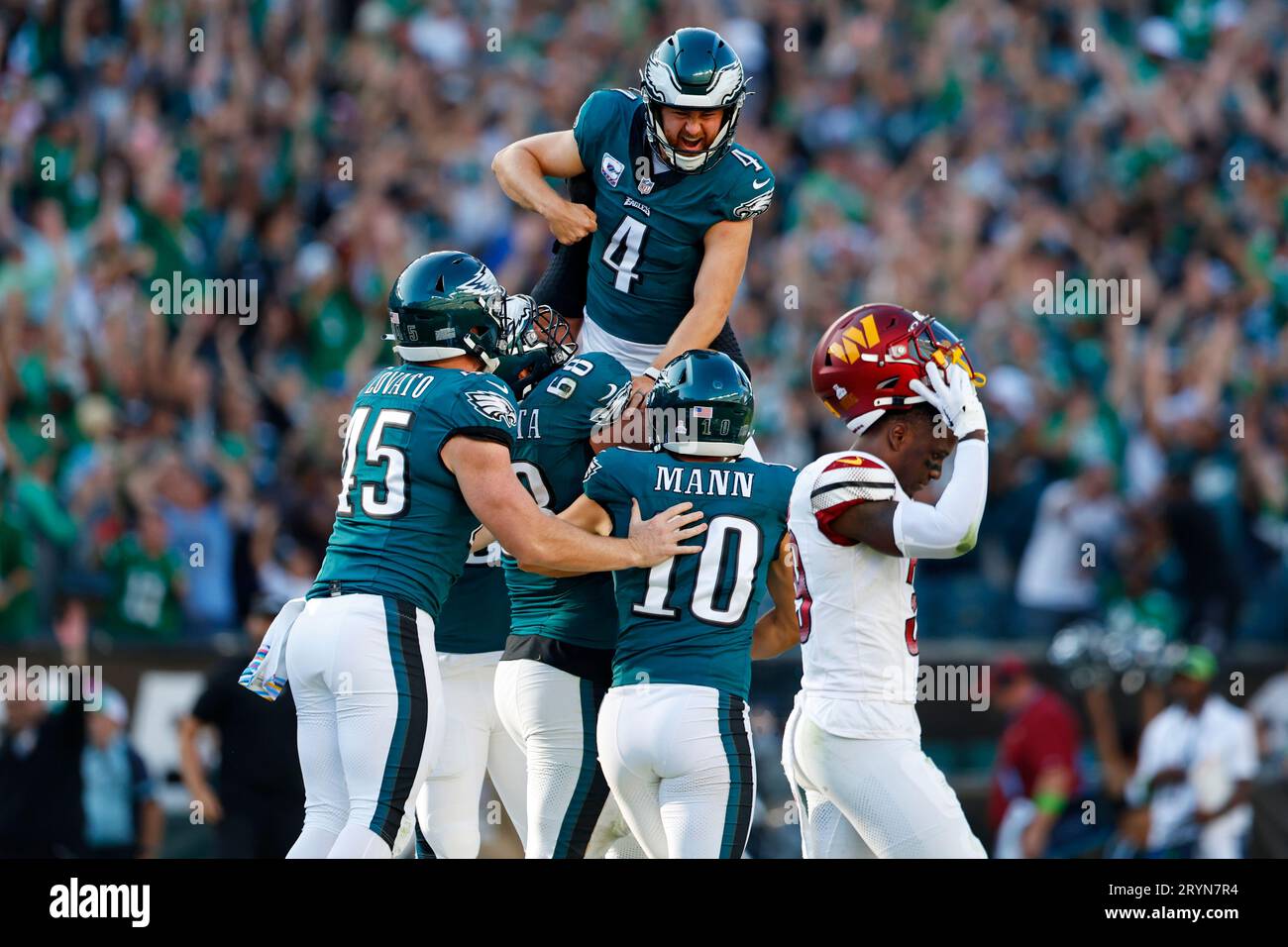 Philadelphia Eagles place kicker Jake Elliott (4) is lifted by offensive  tackle Jordan Mailata (68) after kicking the game winning field goal in  overtime to defeat the Washington Commanders 34-31 during an