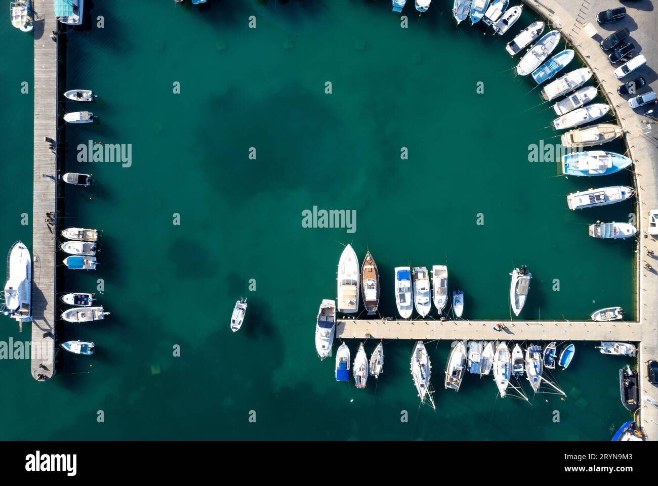 Drone aerial scenery of a fishing port. Fishing boats and yachts moored in the harbour. Stock Photo