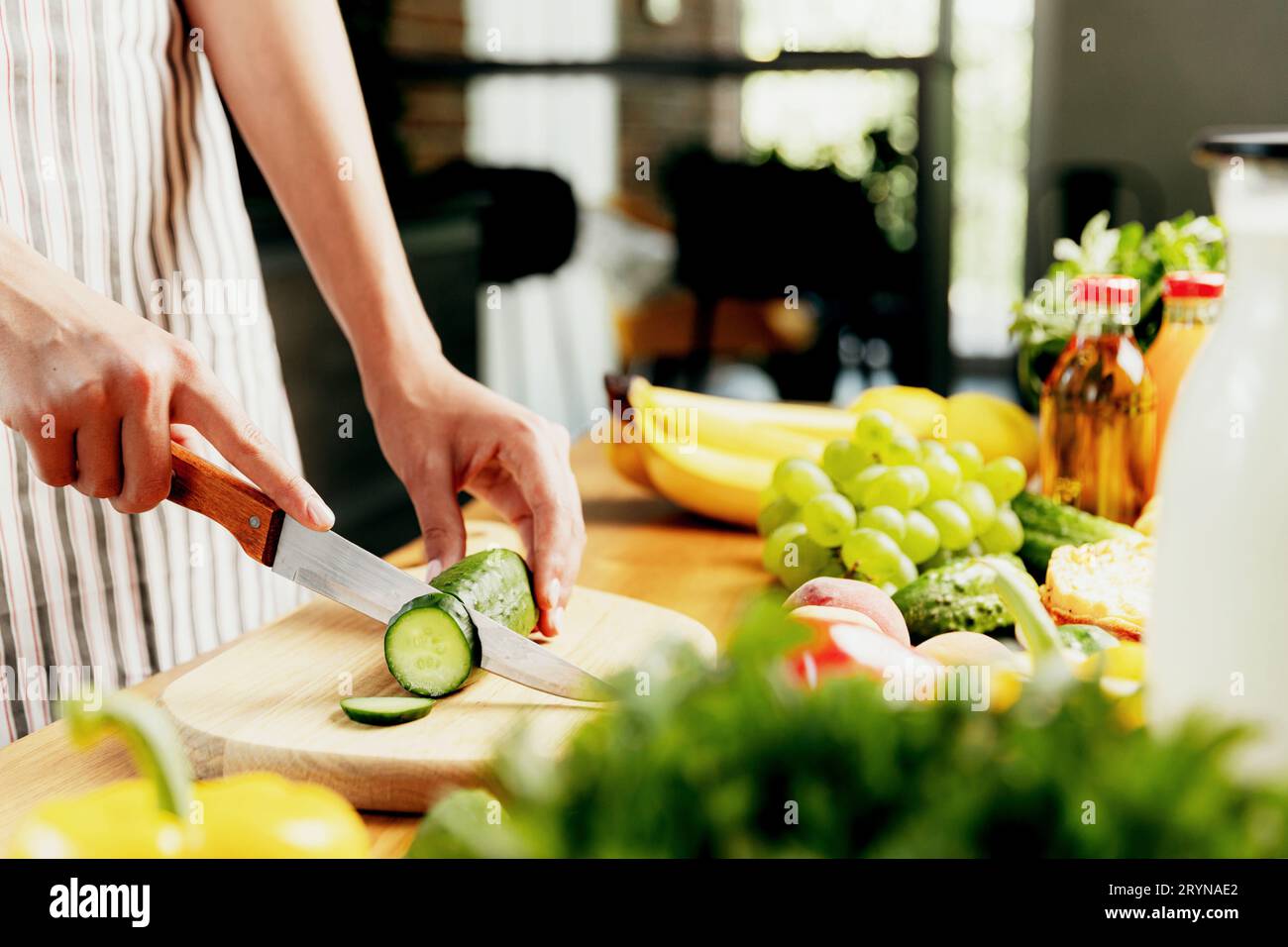 Female hand holding a cucumber with a spiral knife