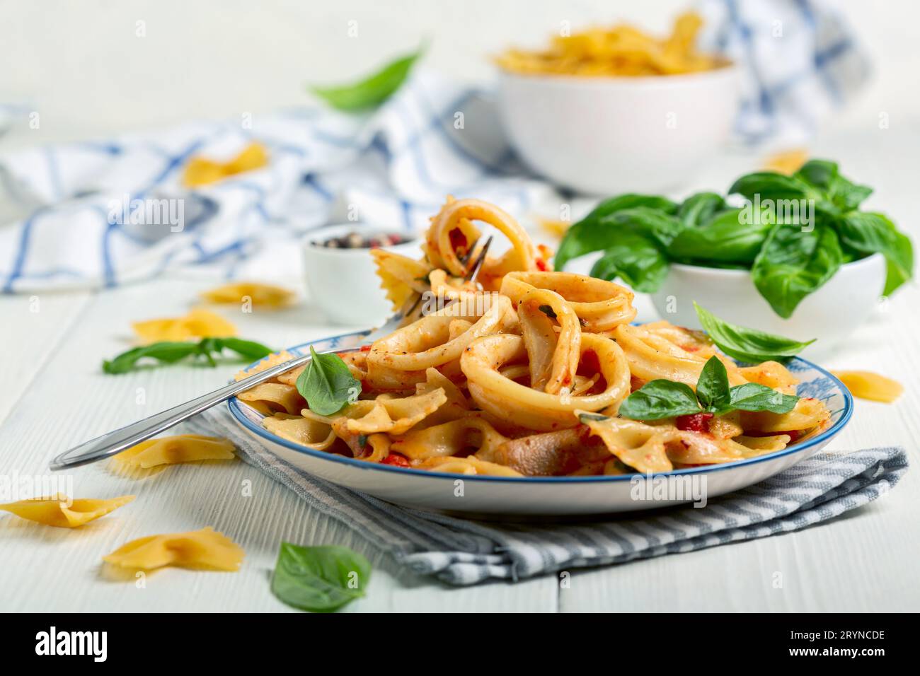 Pasta with calamari and tomato sauce. Stock Photo