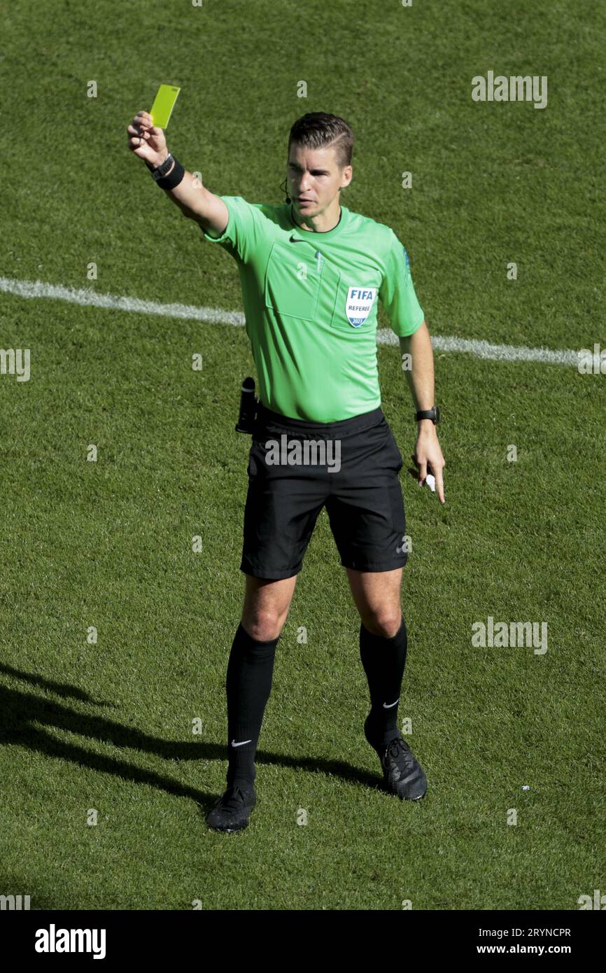 Referee Francois Letexier gives a yellow card during the French