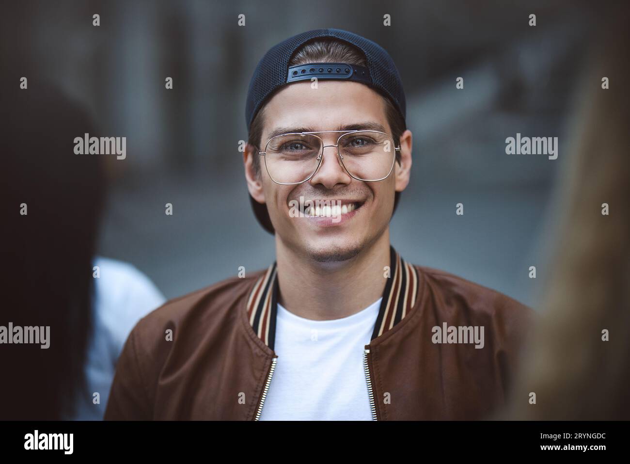 Young happy man posing on a crowded street Stock Photo