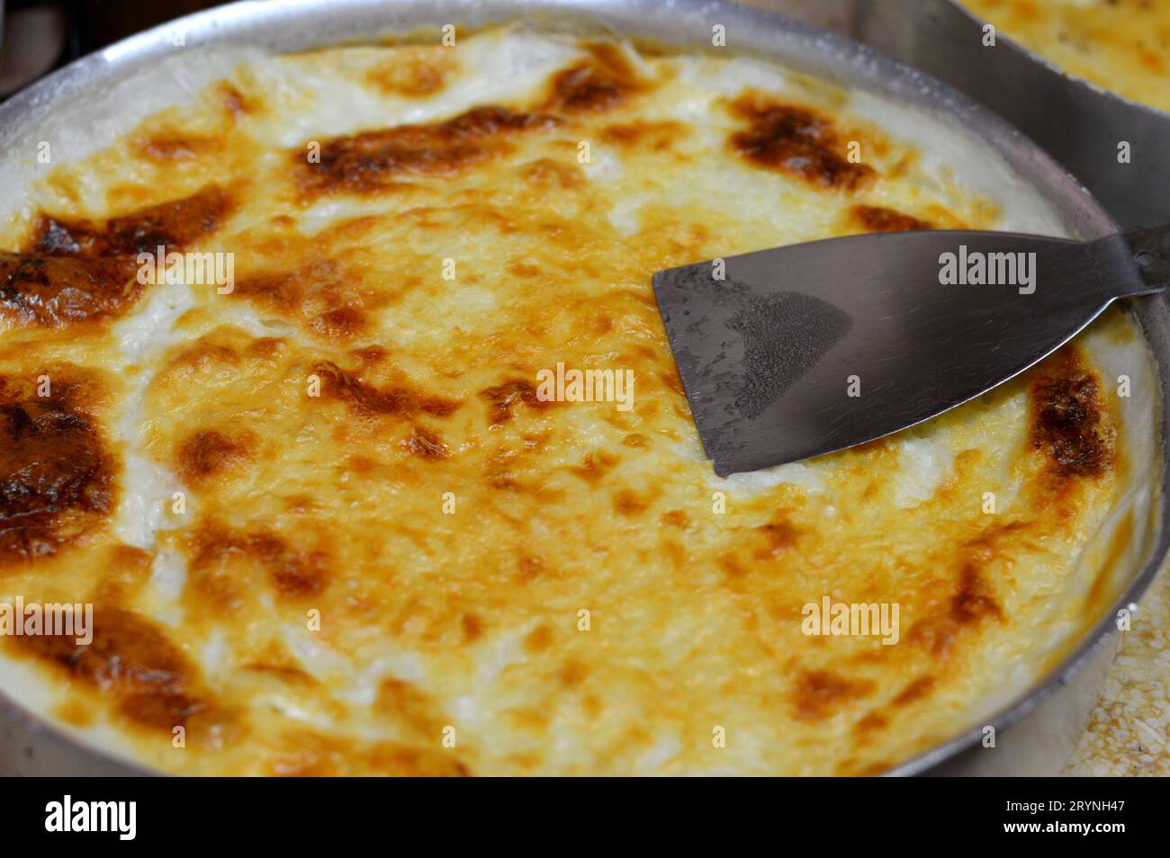 Baked Egyptian rice or Roz muammar's combination of rice, fresh cream, milk, ghee or butter, a very popular Egyptian dish, a simple, sumptuous Egyptia Stock Photo