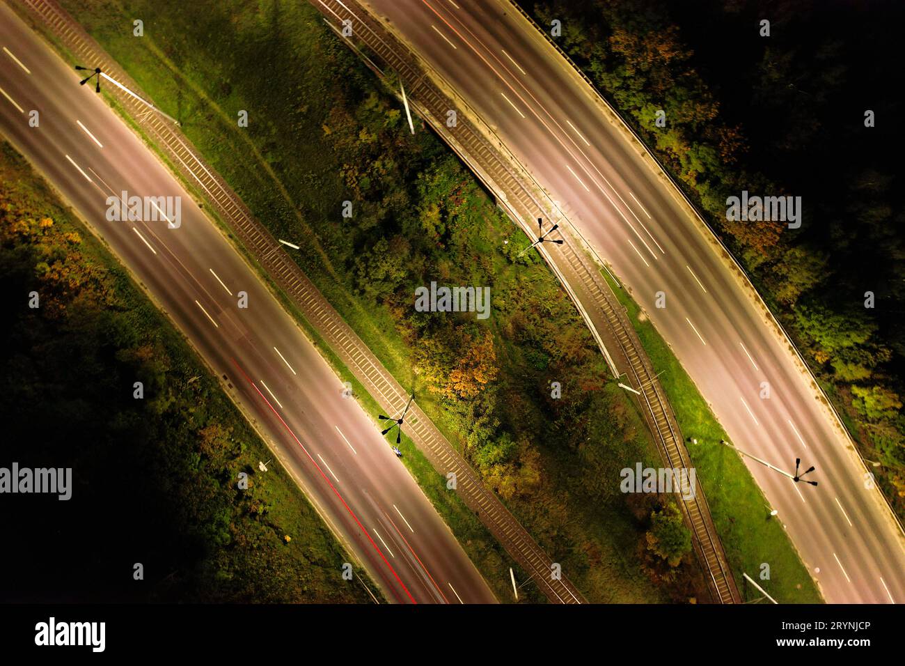 Top down view to road. Romantic night aerial photo of cars traveling. The light on the road at night in city. Background scenic Stock Photo