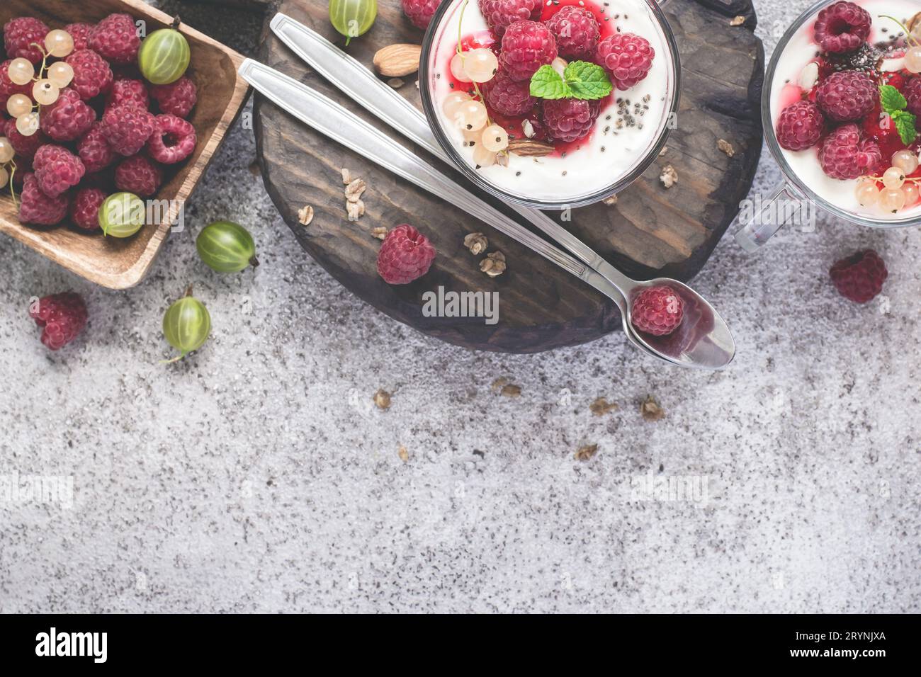Raspberry Fresh Fresh raspberry berries with yogurt or cream in glasses. Summer Stock ...