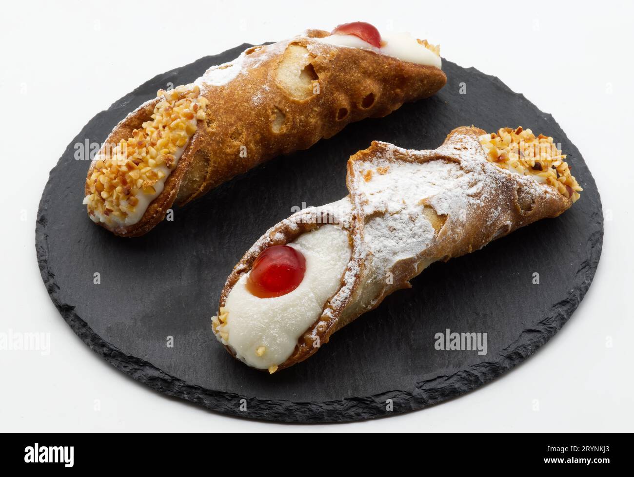 Sweet Sicilian cannoli filled with ricotta cream. Cannolo Siciliano Italian dessert Stock Photo