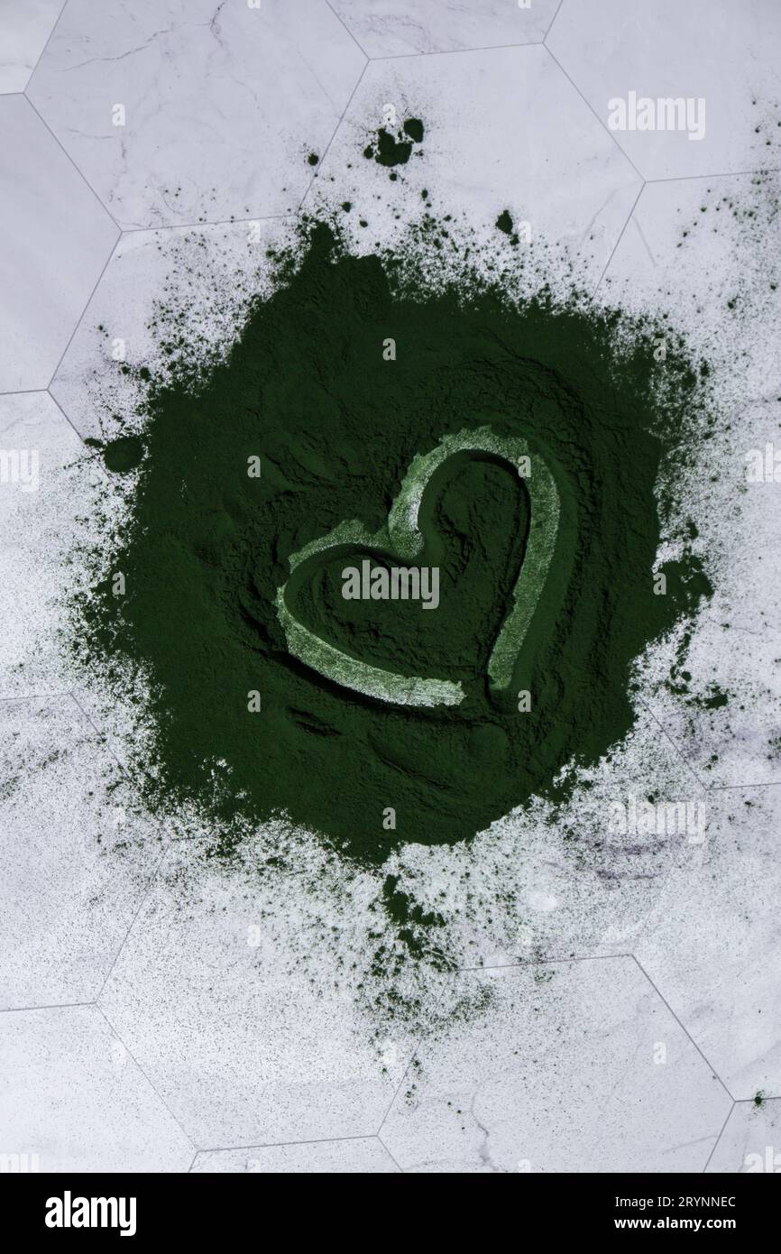 Heart on Blue-green algae Chlorella and spirulina powder. Super powder. Natural supplement of algae. Detox superfood drink cockt Stock Photo