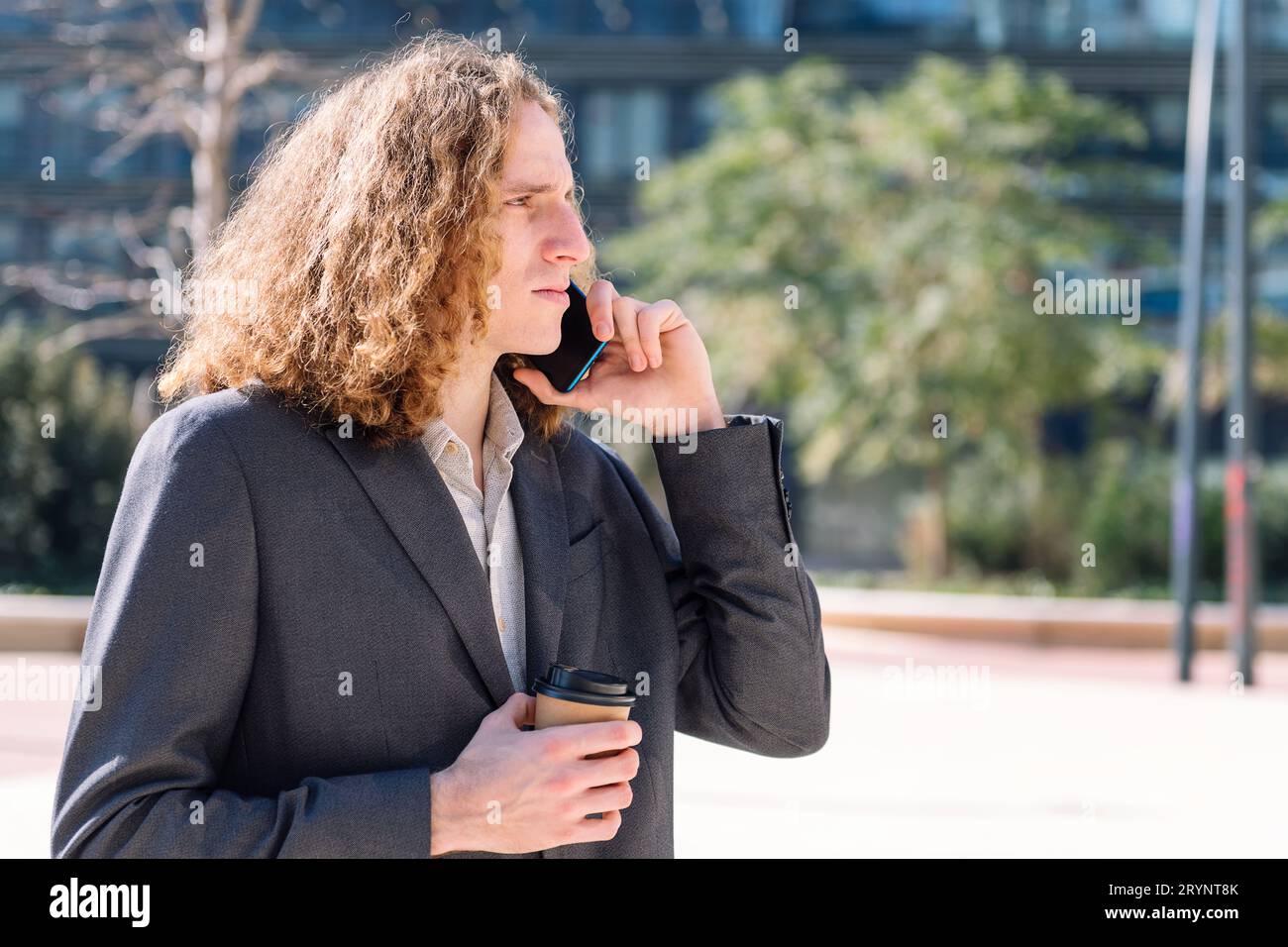 businessman talking by mobile phone outdoors Stock Photo