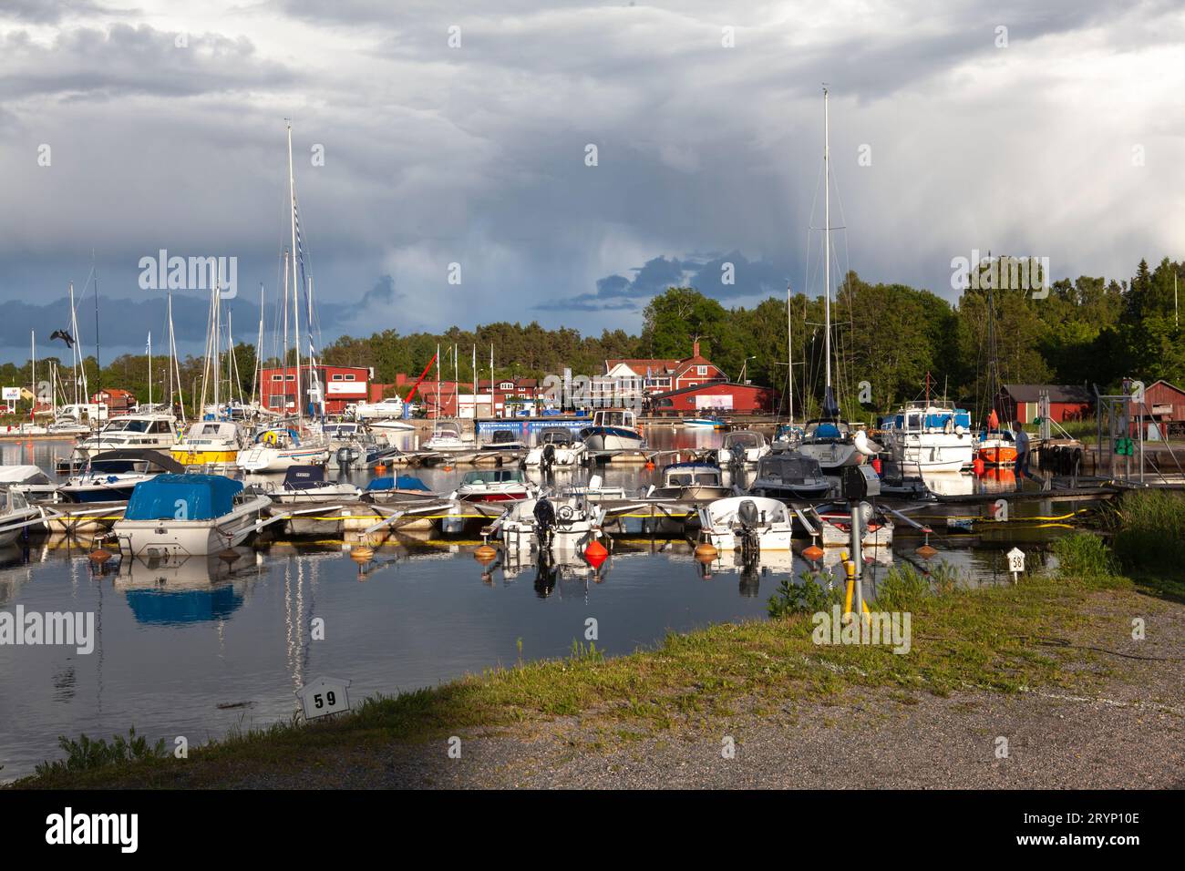 GRISSLEHAMN, SWEDEN ON 25, 2017. The marina on this side is the village by the sea. Evening, sunshine, and showers. Editorial use. Stock Photo