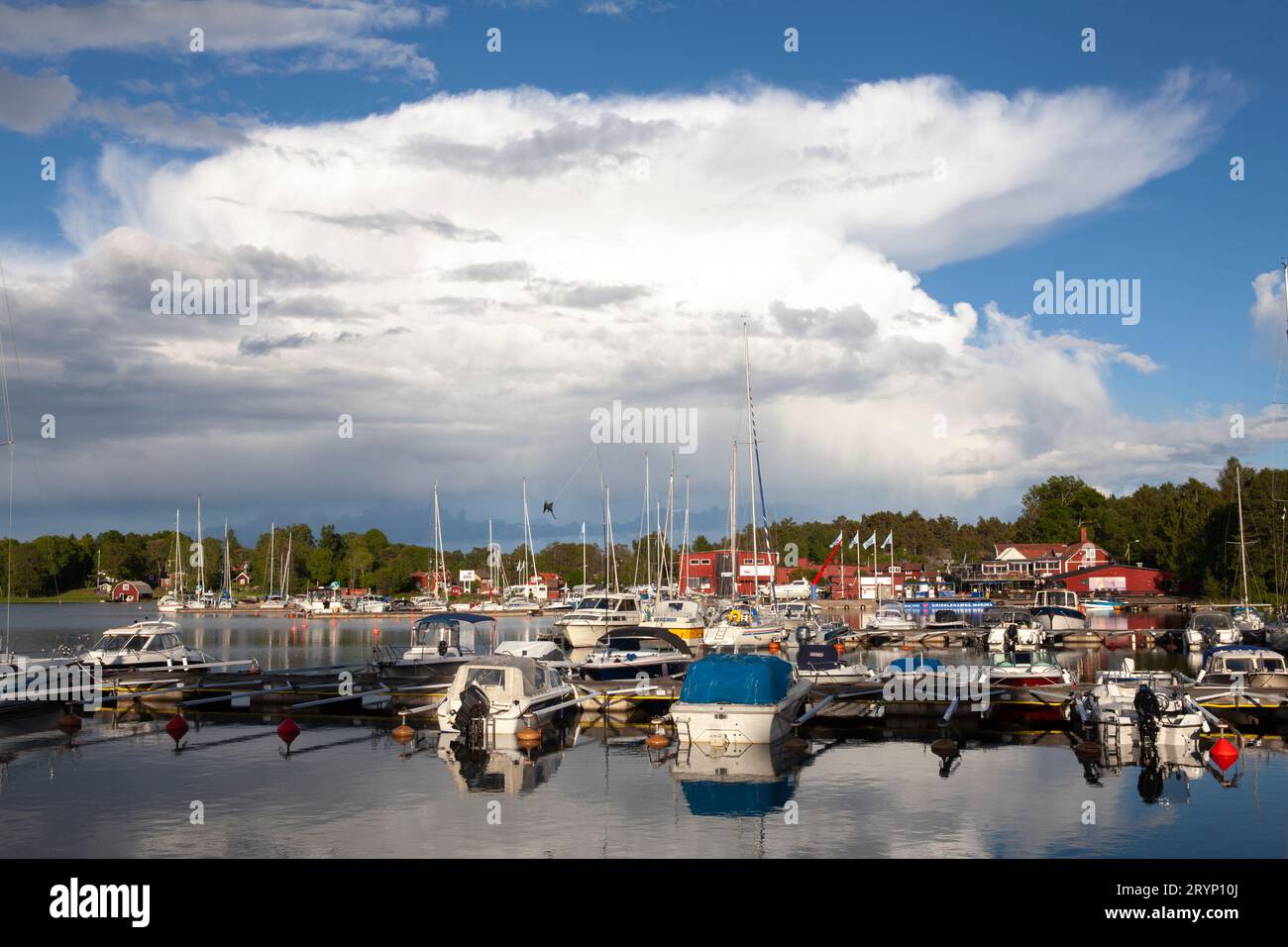 GRISSLEHAMN, SWEDEN ON 25, 2017. The marina on this side is the village by the sea. Evening, sunshine, and showers. Editorial use. Stock Photo