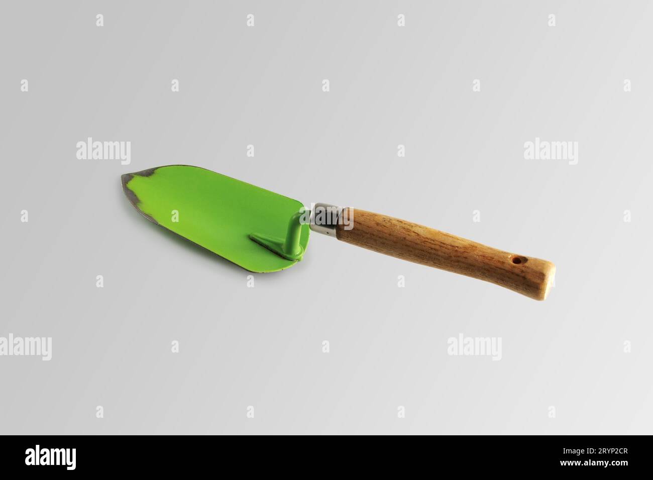 Garden shovel green. Close-up. Isolated on a gray background. Stock Photo