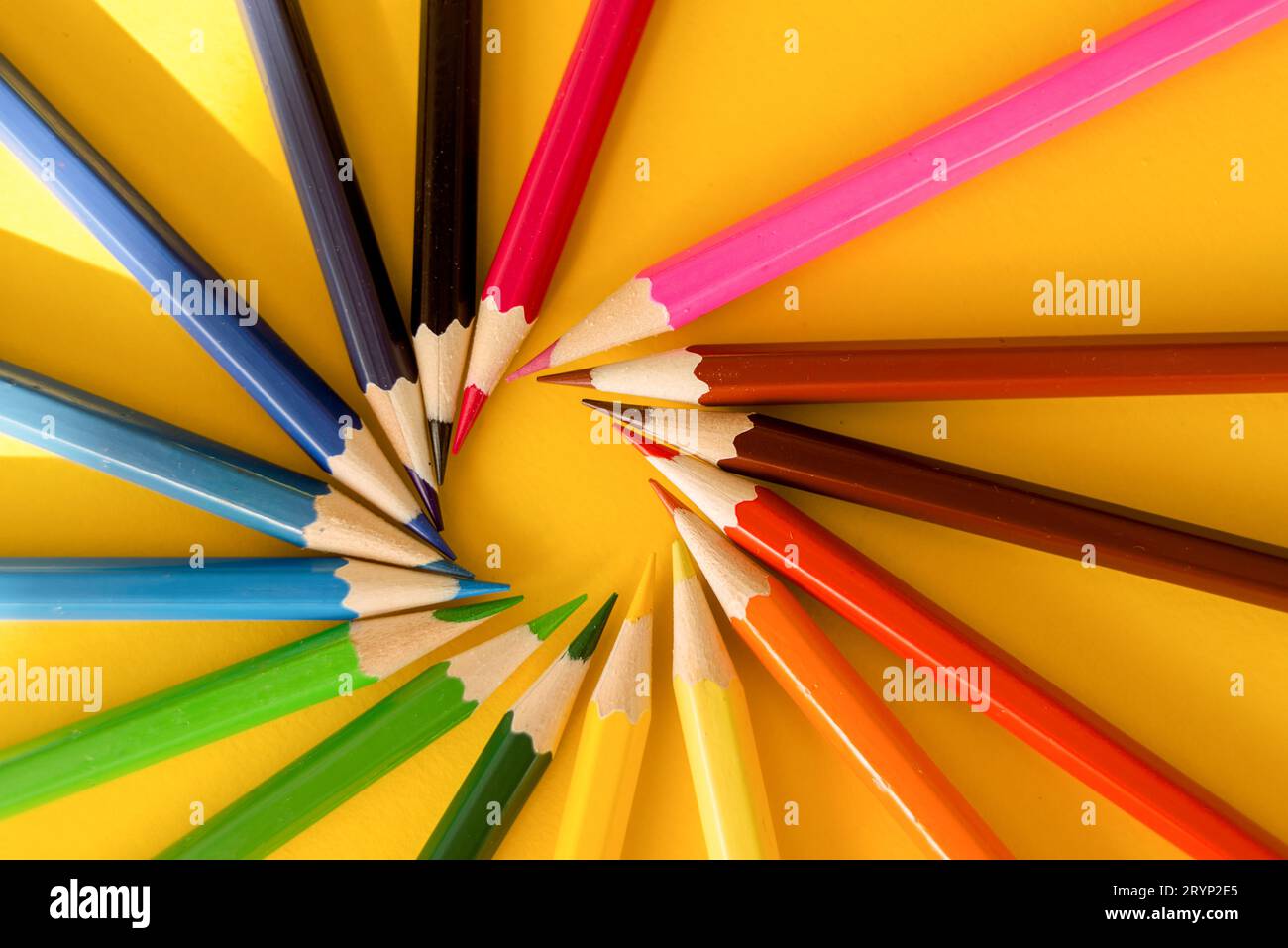 Lots of colored pencils on the yellow background of the desk. Back to school. Children's Creativity and Education. High quality photo Stock Photo