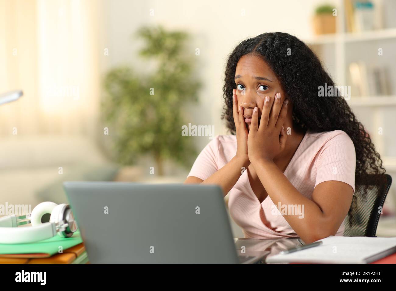 Concerned black student e-learning looking at you complaining at home Stock Photo