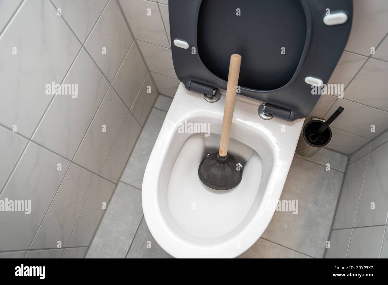 Bavaria, Germany. 29th Sep, 2023. Clogging in the toilet with a plunger