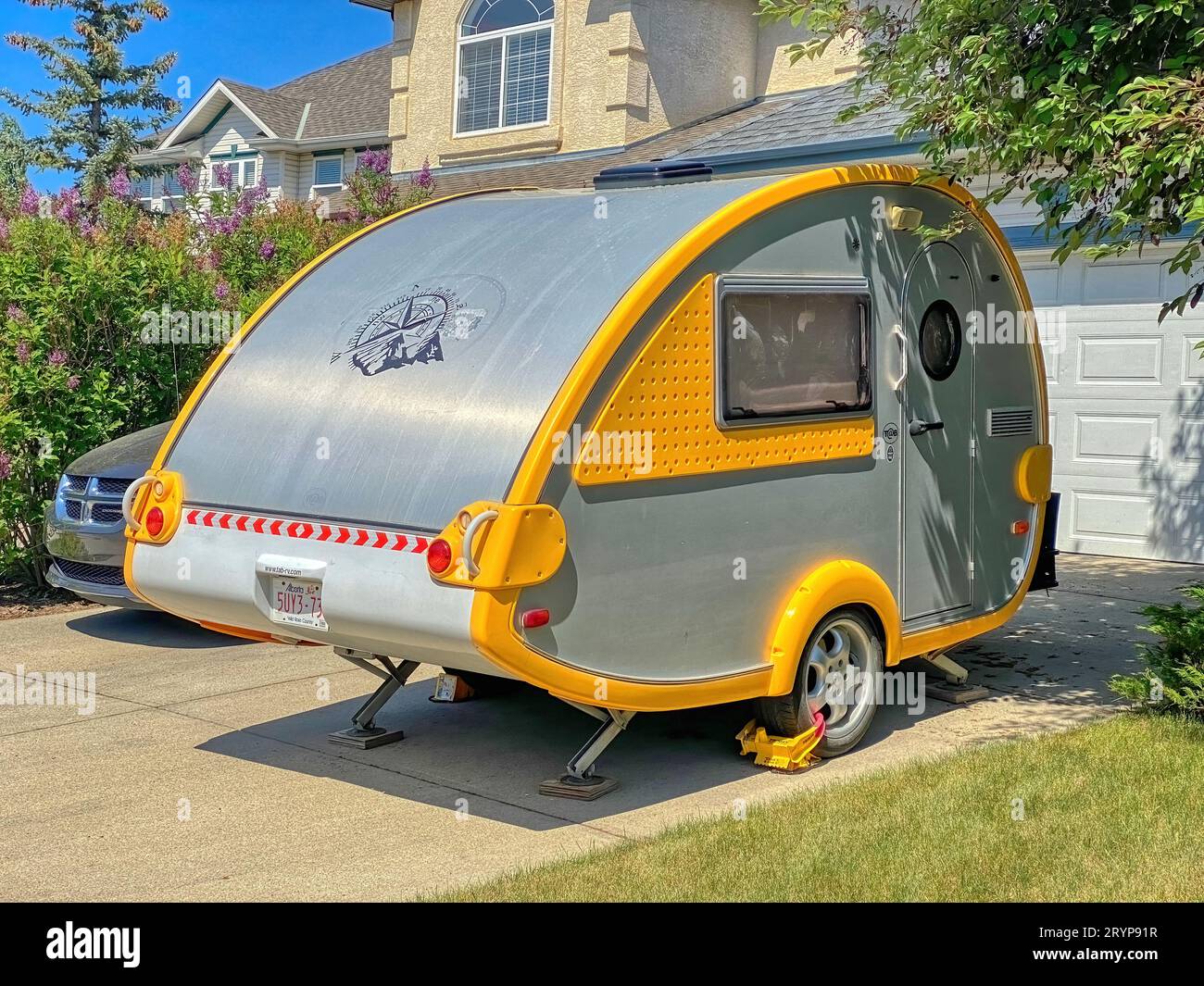 Calgary, Alberta, Canada. Jun 6, 2023.A Teardrop Camping Trailer parked in front of a house. Stock Photo