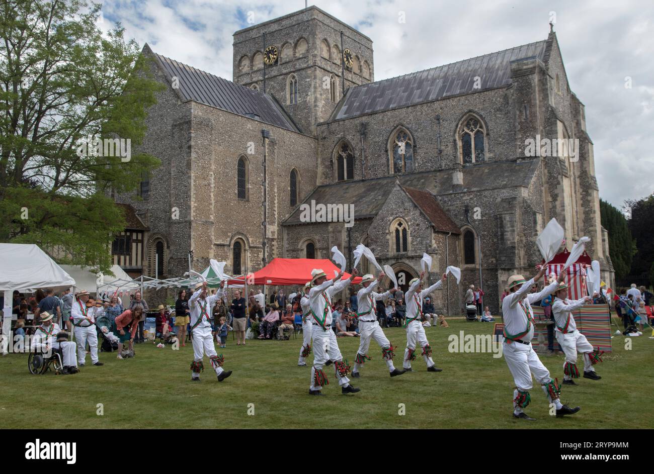 The Hospital of St Cross and Almshouse of Noble Poverty annual summer fete that has taken place for over 150 years. Morris dancing in the background the Church of St Cross a private chapel of the Hospital of St Cross. About 2,000 people attended in 2022. Winchester, Hampshire, England 25th June 2022.  2020s UK HOMER SYKES Stock Photo