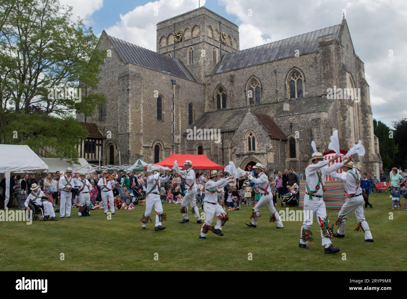 The Hospital of St Cross and Almshouse of Noble Poverty annual summer fete that has taken place for over 150 years. Morris dancing in the background the Church of St Cross a private chapel of the Hospital of St Cross. About 2,000 people attended in 2022. Winchester, Hampshire, England 25th June 2022.  2020s UK HOMER SYKES Stock Photo