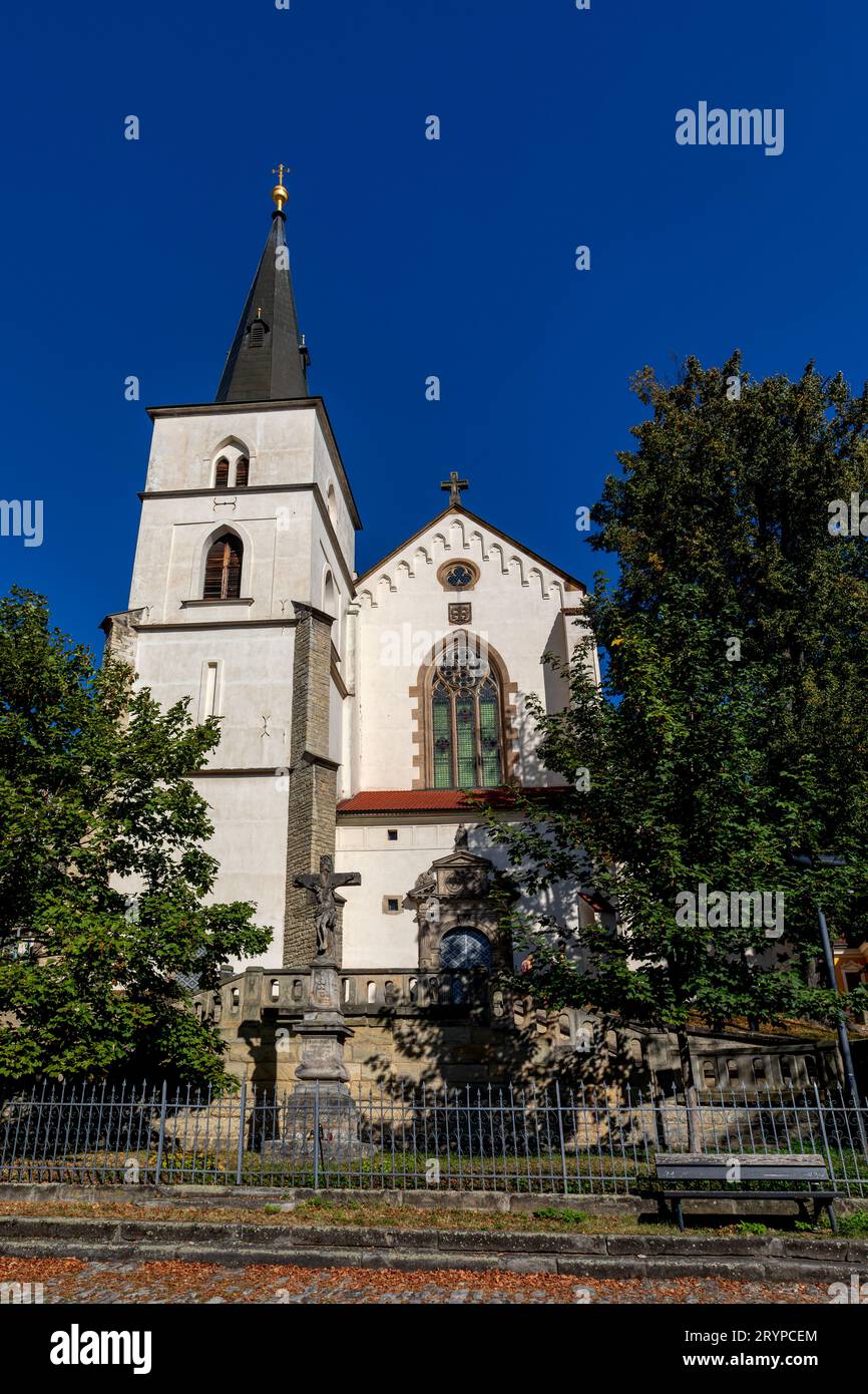 Gothic medieval church of the Exaltation of the Holy Cross with tower at sunny summer day, Fountain in Monastery Garden, Sculpture Chic. Litomysl, Cze Stock Photo