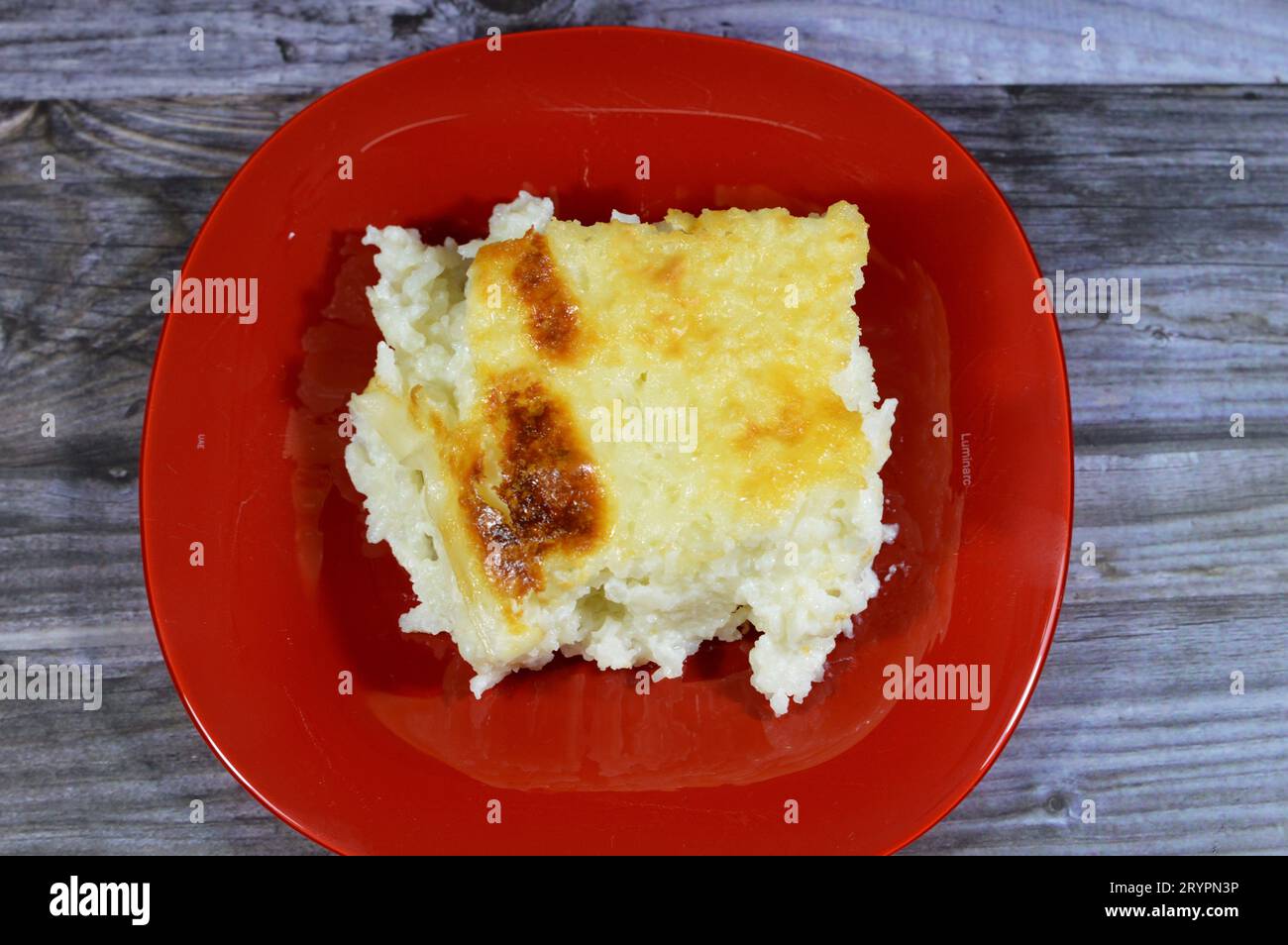 Baked Egyptian rice or Roz muammar's combination of rice, fresh cream, milk, ghee or butter, a very popular Egyptian dish, a simple, sumptuous Egyptia Stock Photo