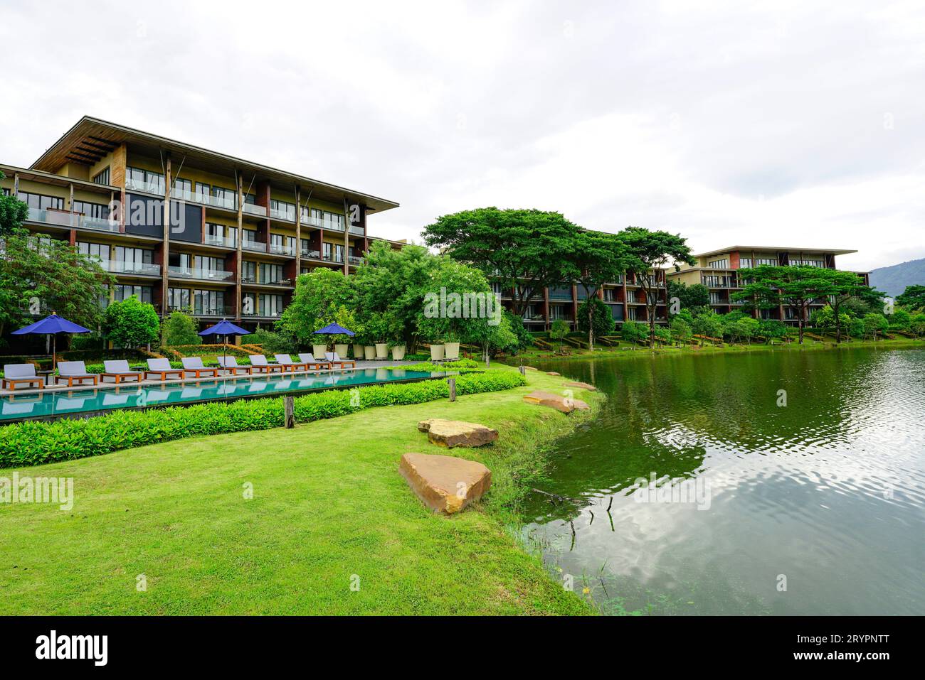 Sustainable hotel. Luxury hotel in the forest. Green luxury hotel in the valley. Nature retreat. Green landscape of tropical paradise resort. Lake Stock Photo