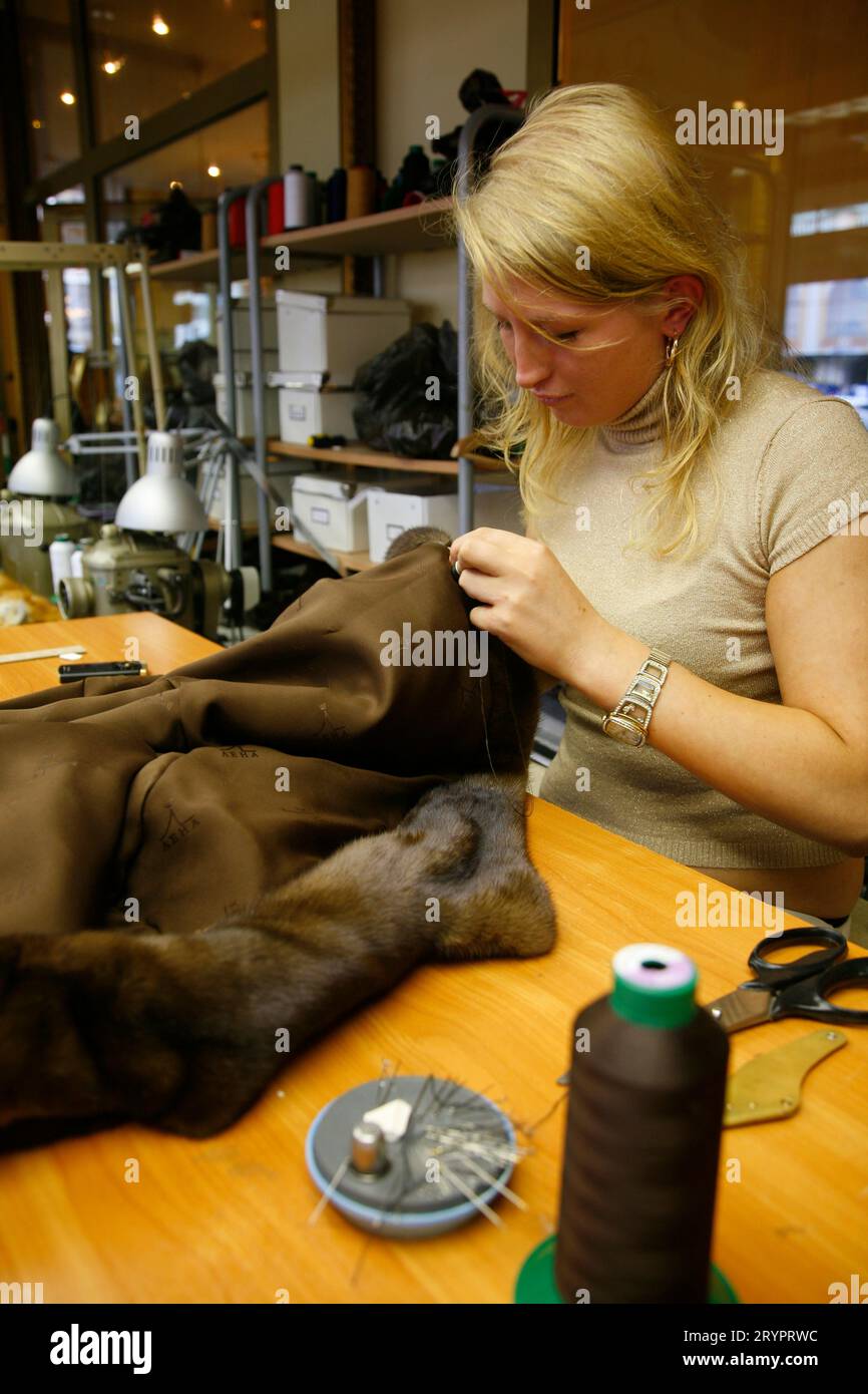 Tailor making sable coats, St. Petersburg, Russia. Stock Photo