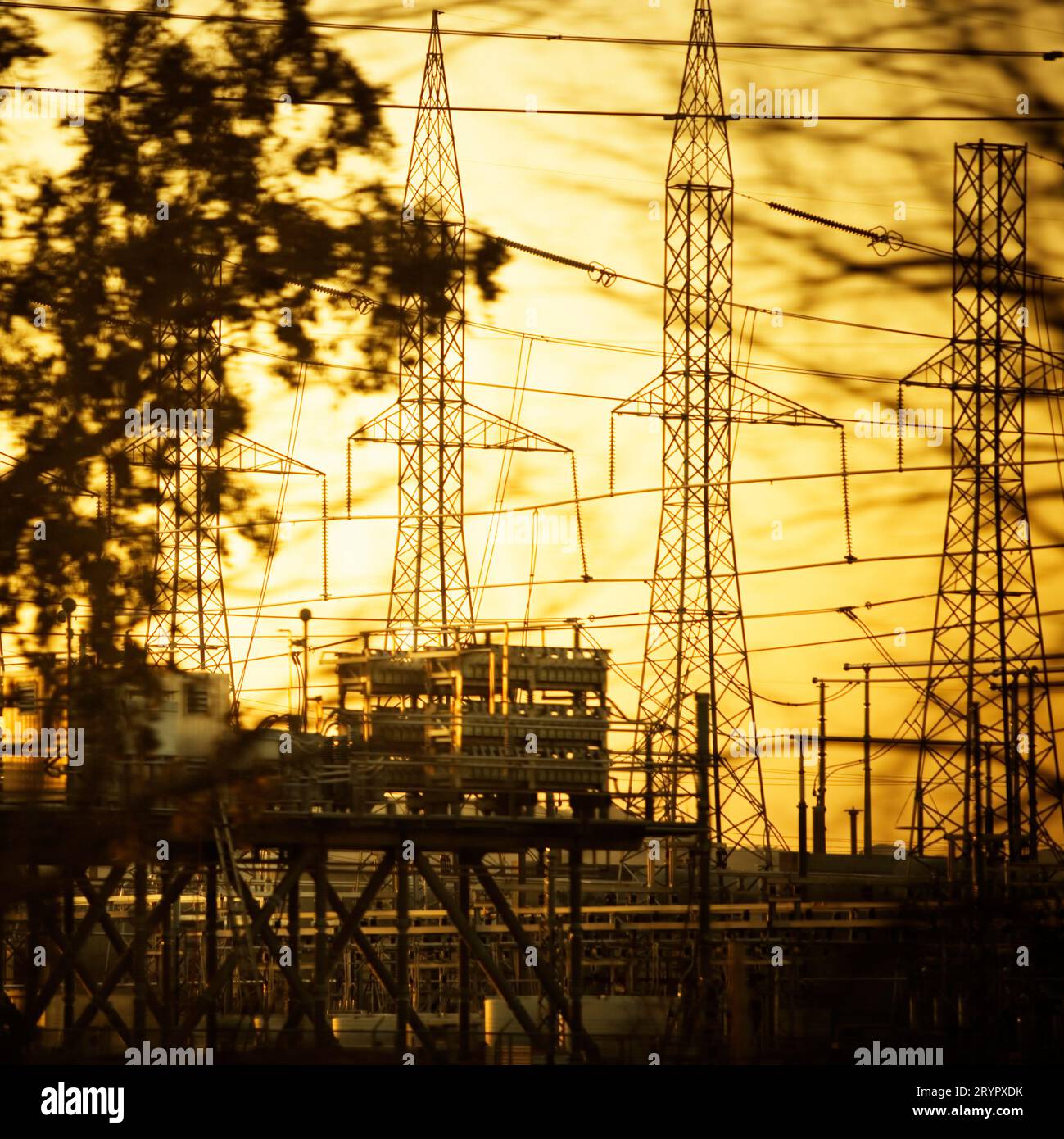 Electrical power transfer station through the trees and wires Stock
