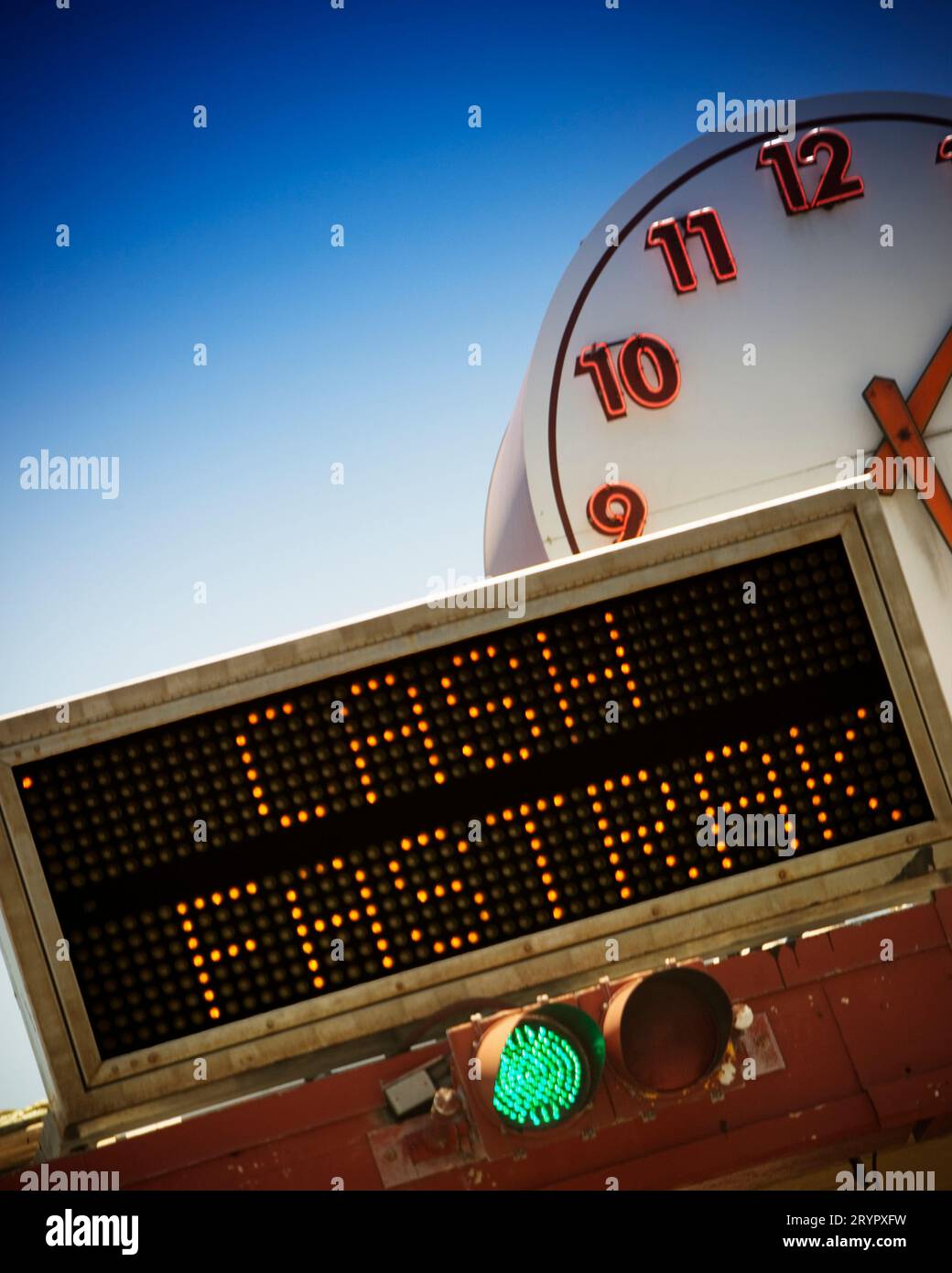 Illuminated cash, fast track sign and clock at the toll plaza on the Golden Gate Bridge tower and cables, San Francisco, California. Stock Photo