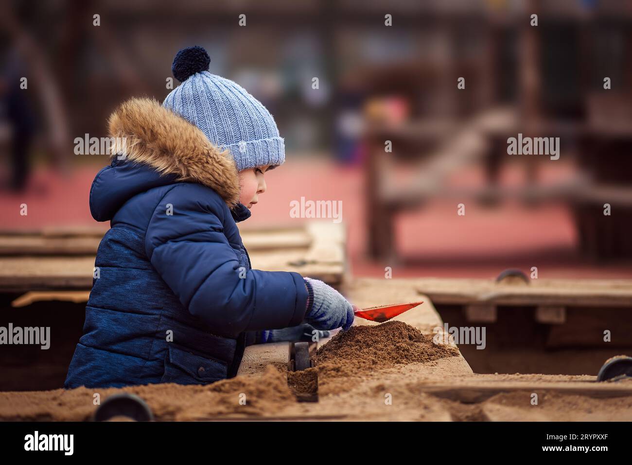 little boy playing in the sandbox Stock Photo