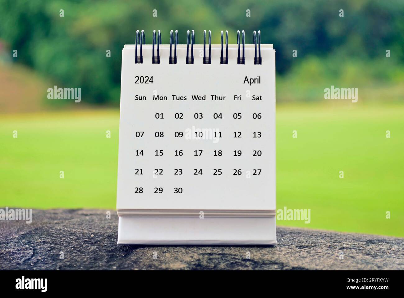 January 2024 white calendar with green blurred background. New year ...